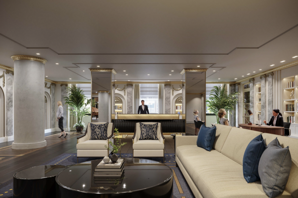 a lobby with a man standing behind a reception desk